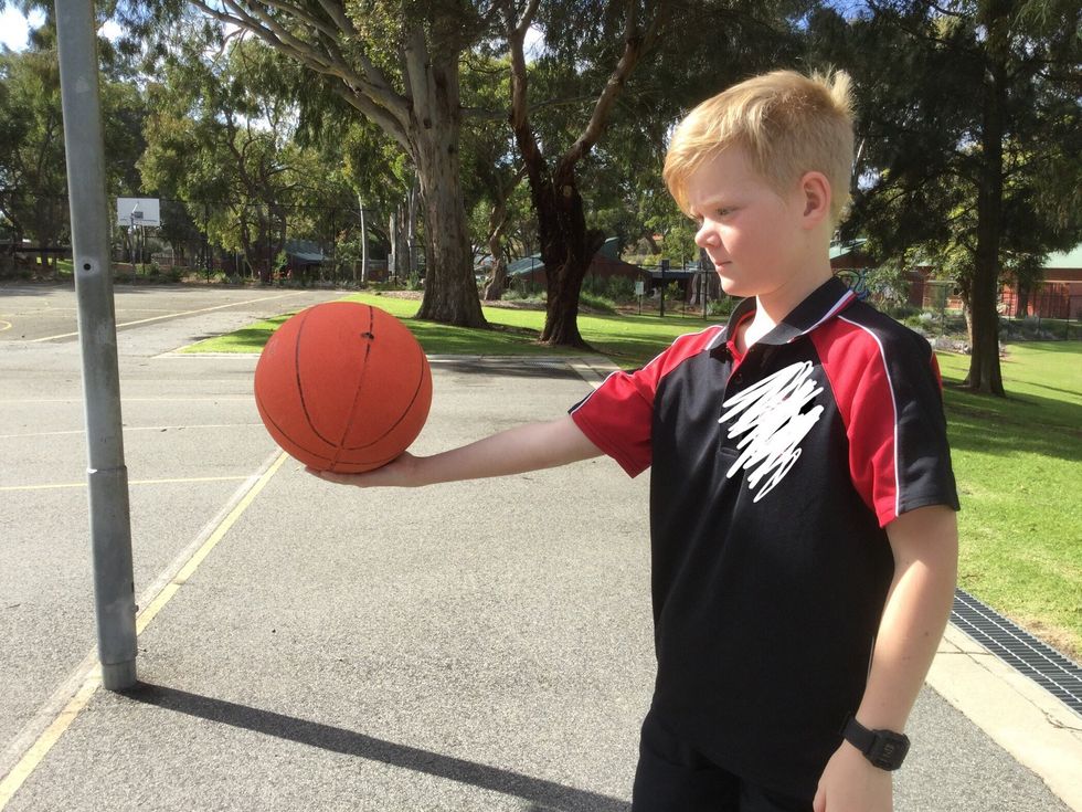 Bend your knees and put your undominant handon the left side of the