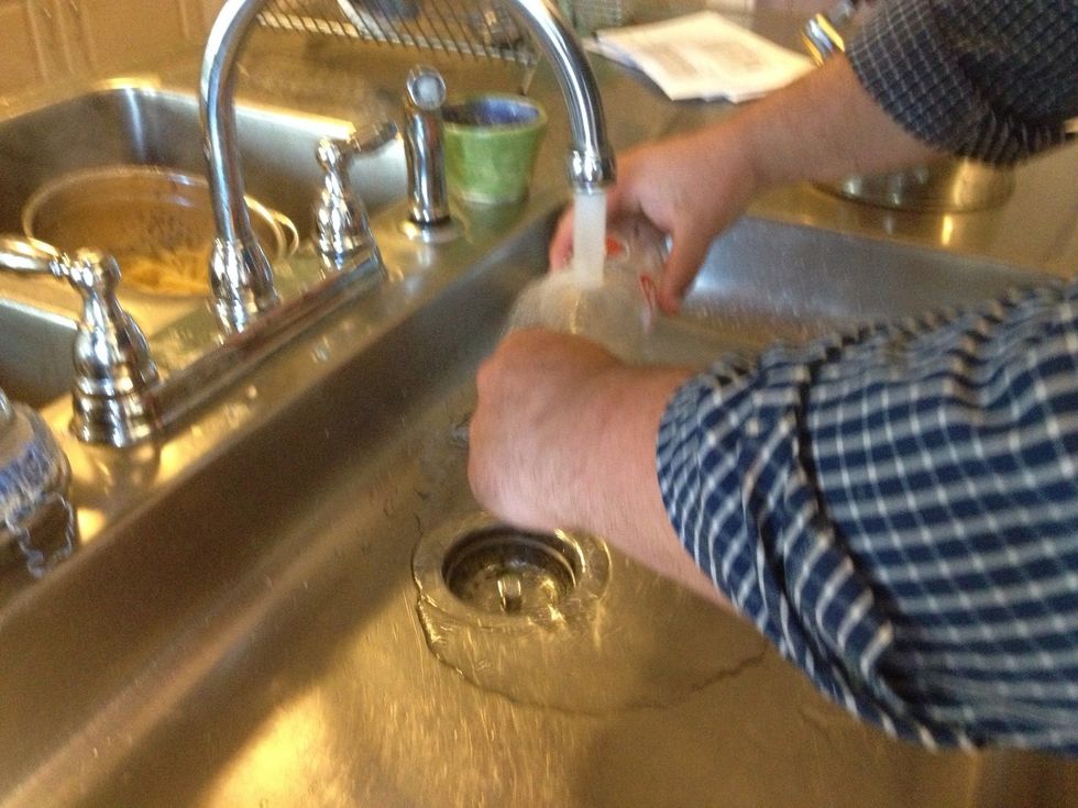 Hold the bottle with both hands under the cold water. You should hear see and feel a break occurring.