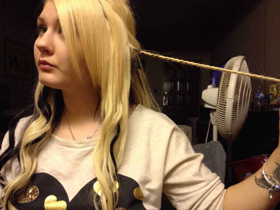 Hold the braid out so you can begin to cross it over your head