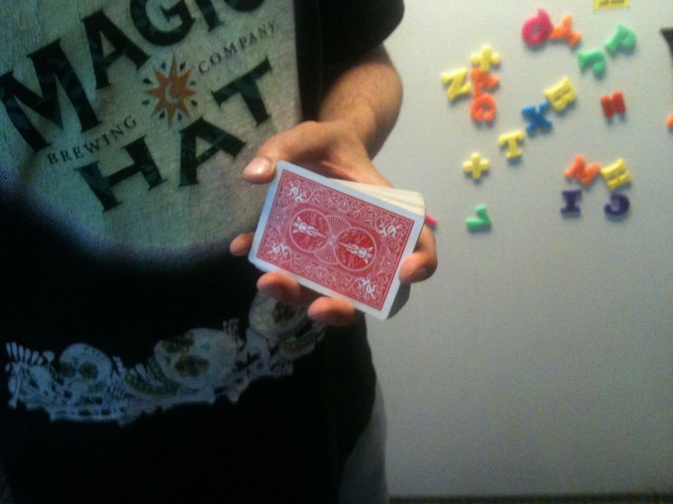 Hold the deck like you see in this image. Index finger on outer edge. Little finger on inner edge. Middle two fingers on lower edge and thumb at the inner top corner.