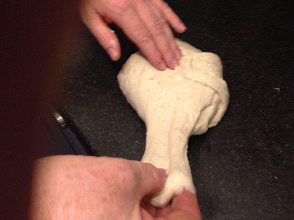 Hold the dough in the centre and stretch each point in turn, pulling the dough out from each point out and then back to the centre, using your other hand to hold it in place.