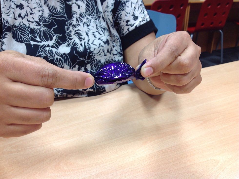 Hold the ends of the wrapper