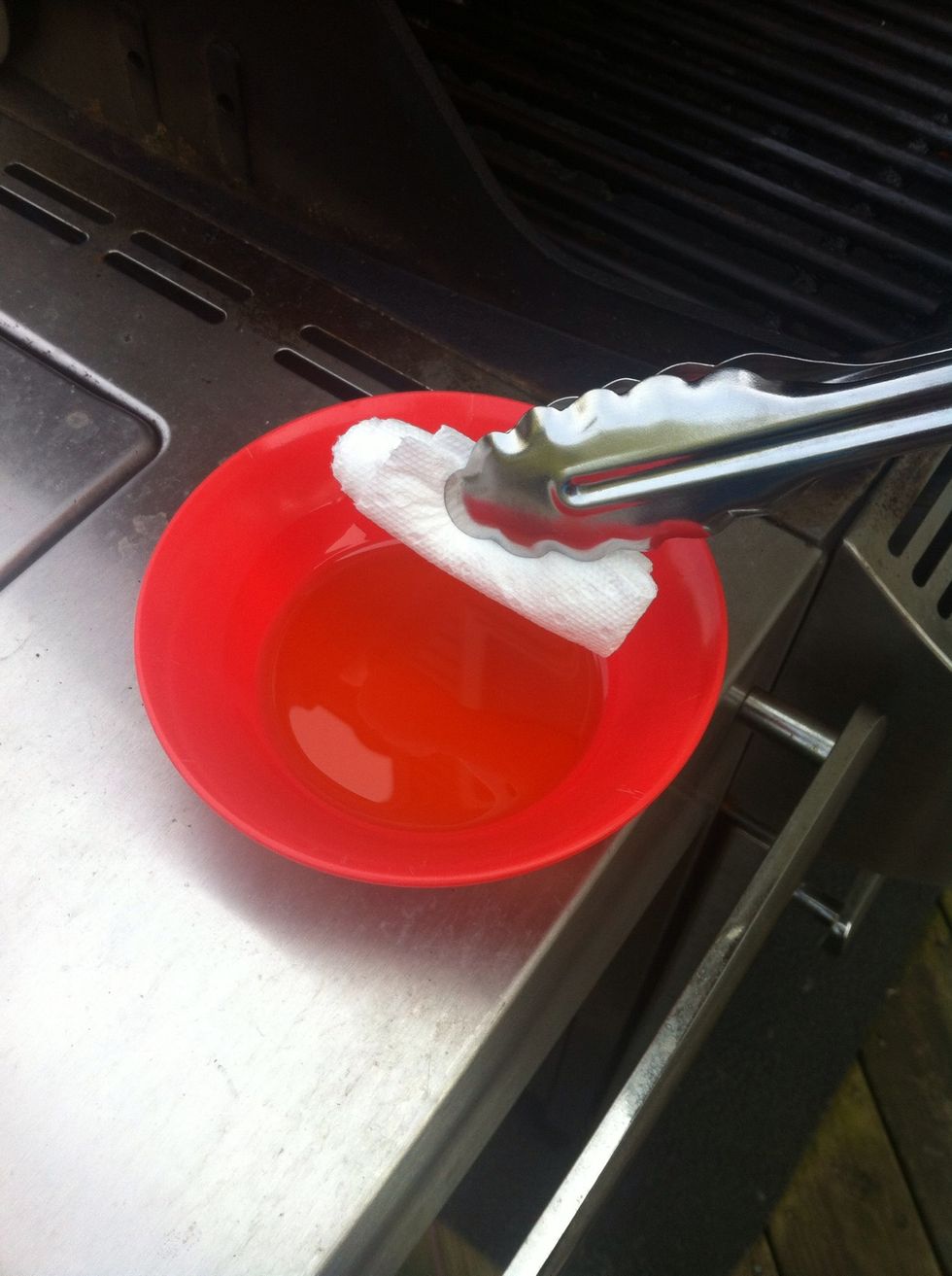 Hold the paper towel with tongs and dip in the oil to oil the grill bars. Don't use too much oil or you'll have flare-ups.