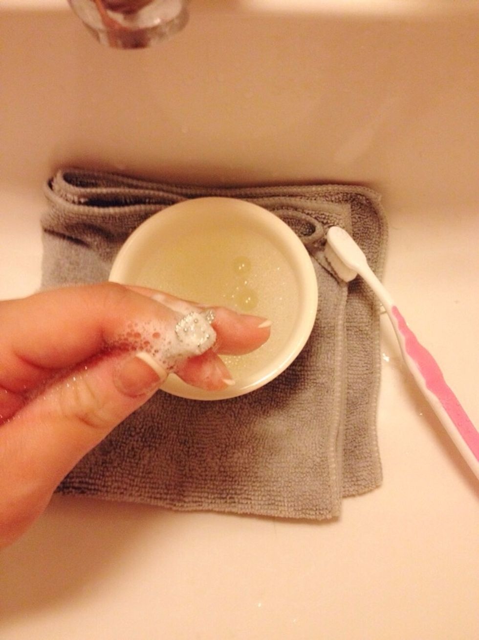 Hold the ring securely on your index finger. Start brushing gently in secular motions, all around. Don't forget the inside of the ring.