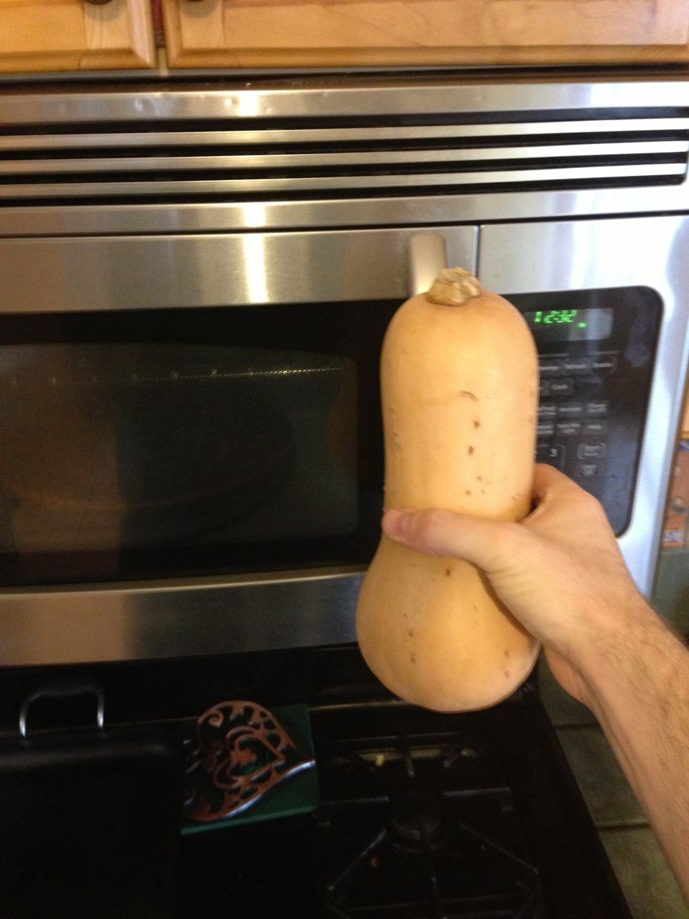Hold the squash in one hand while you open the microwave with the same hand for optimal visibility.