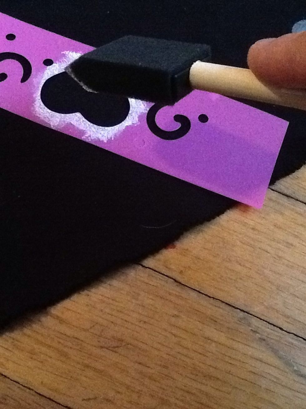 Hold the stencil down and then dab the paint on the the desired area