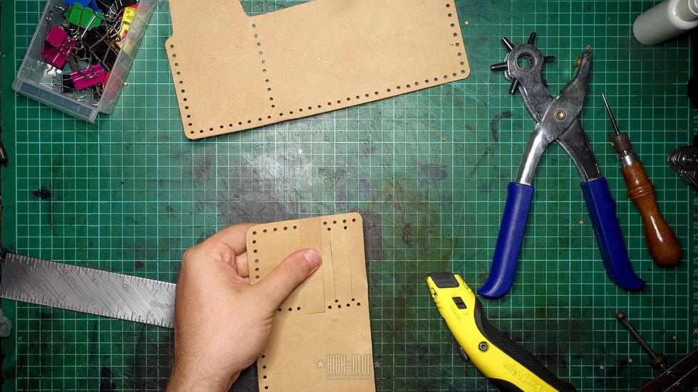 Hold the strip one hole from the bottom card slot, mark the position of the 2 holes you\u2019ll need on either side and punch them. Make sure that you leave enough space between holes.