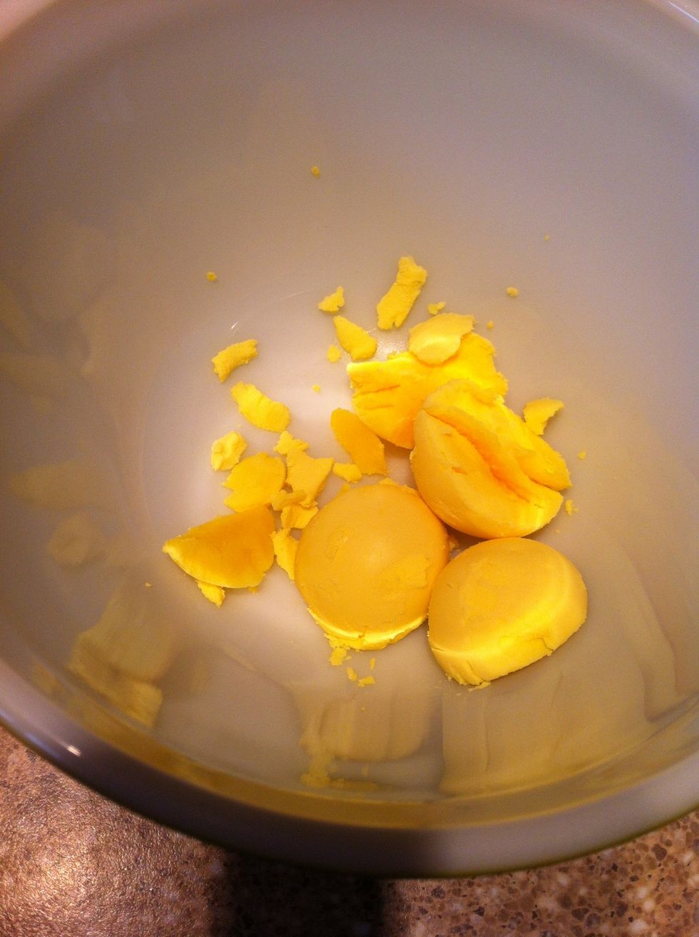 Hold upside down or use a spoon to remove yolks