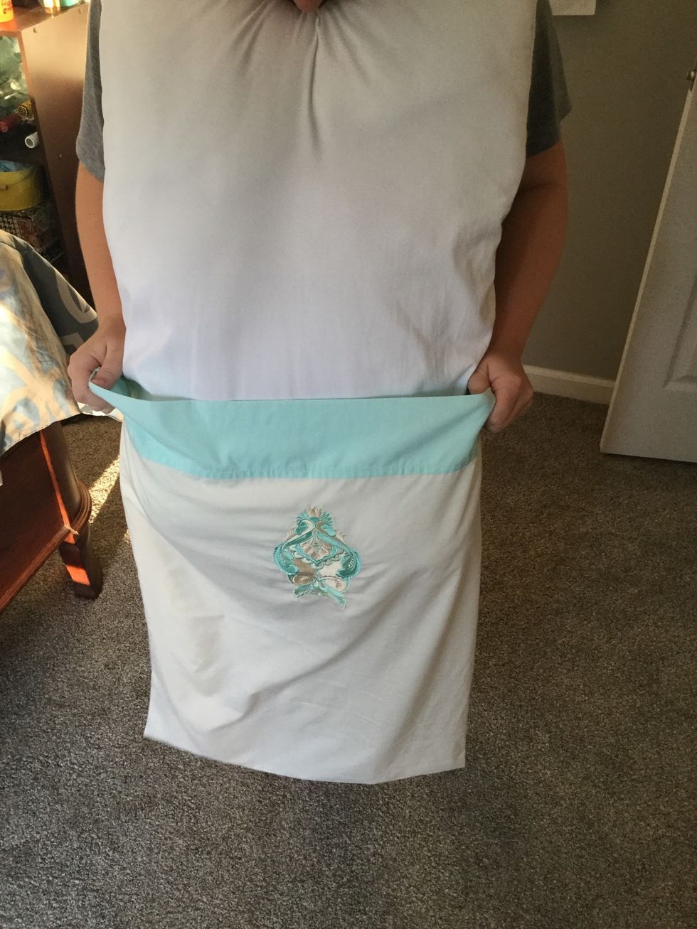 Hold you pillow at your chin and pull pillowcase up the length of the pillow until it is completely inside the pillowcase