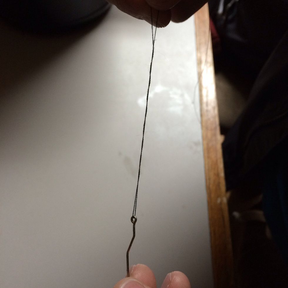 Holding both lines in your right hand and the hook in your left hand twist the hook 5 to 6 times