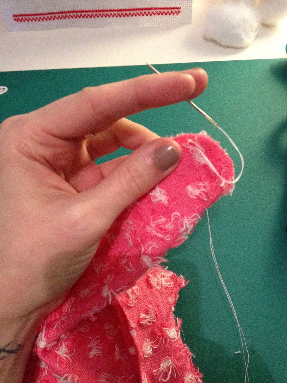 Holding onto the edges of the legs, stitch round them in a straight line. When you get to the top of each leg stitch a tight knot. Make sure you leave a gap at the bottom to turn the sock inside out.