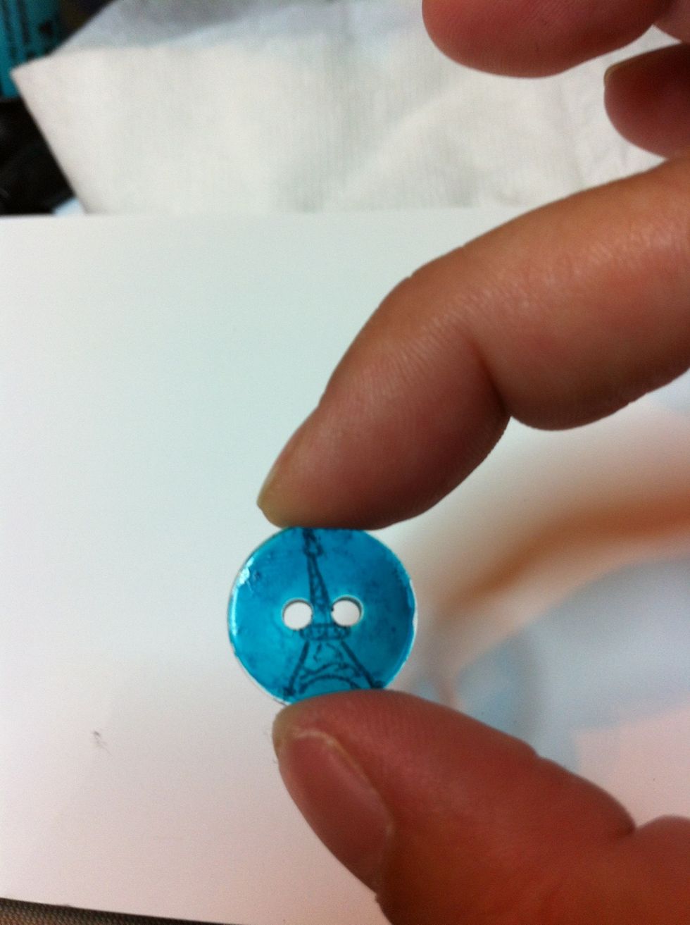 Holding the sides, lift the button straight up off the stamp.