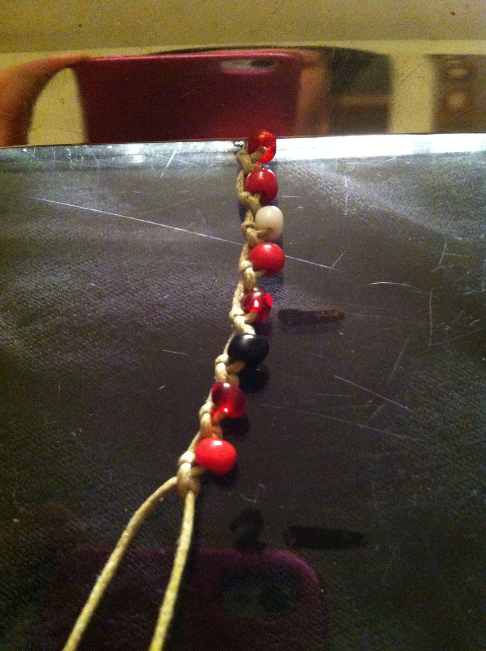 Holding the top loop and the loose strand tug gently in opposite directions. This will loosen and straiten, and your beads should all fall into line.