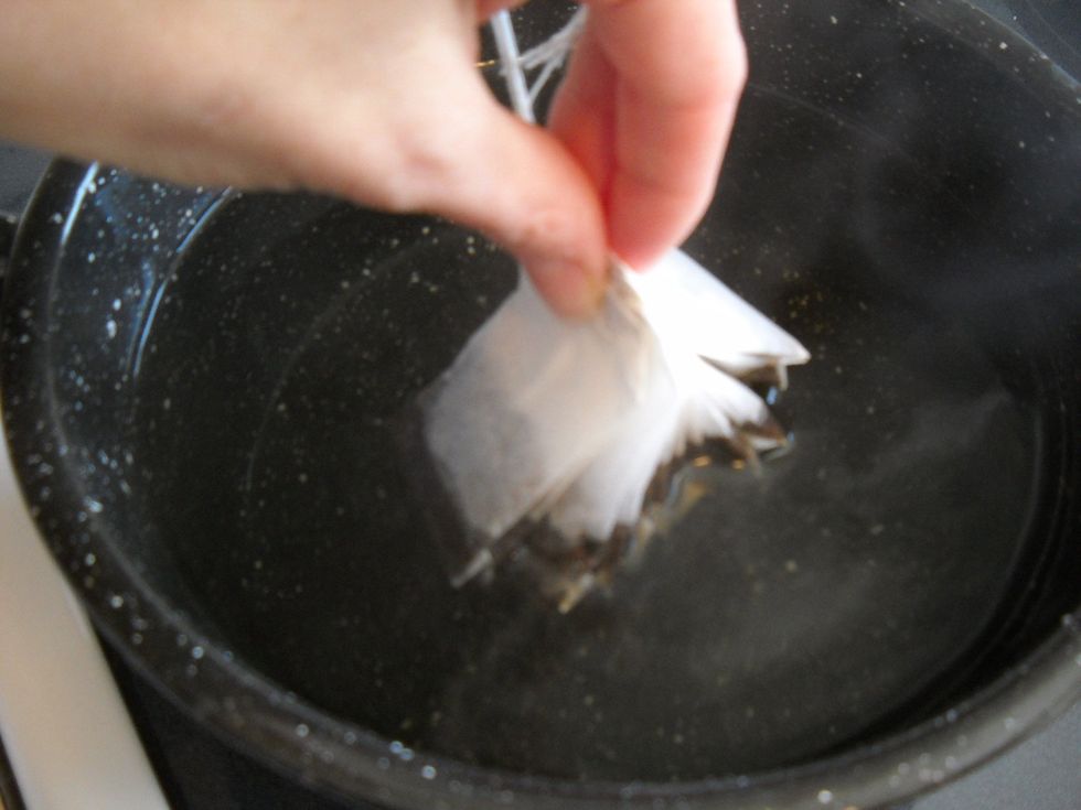 Holding the tops of the tea bags together, swish the bags in the hot water to get them wet.