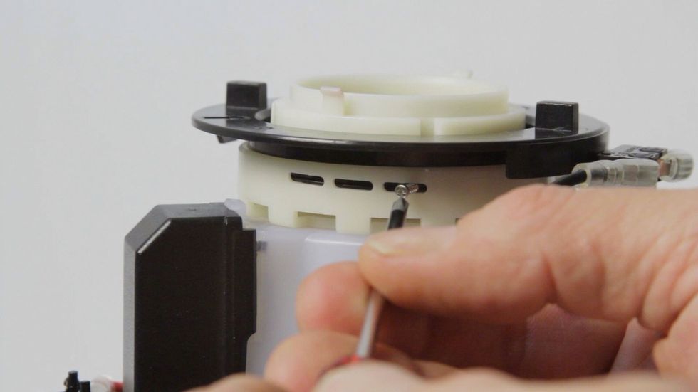 Holding the upper white ring, I turned the black ring to move the screw holes (there are 2 available) to line up behind the fine window. I then replaced the screw.