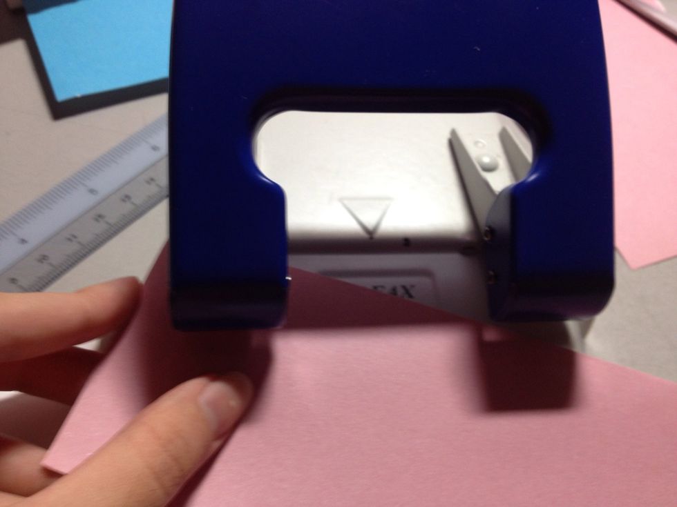Hole punch the top left corner of the paper with a single hole.