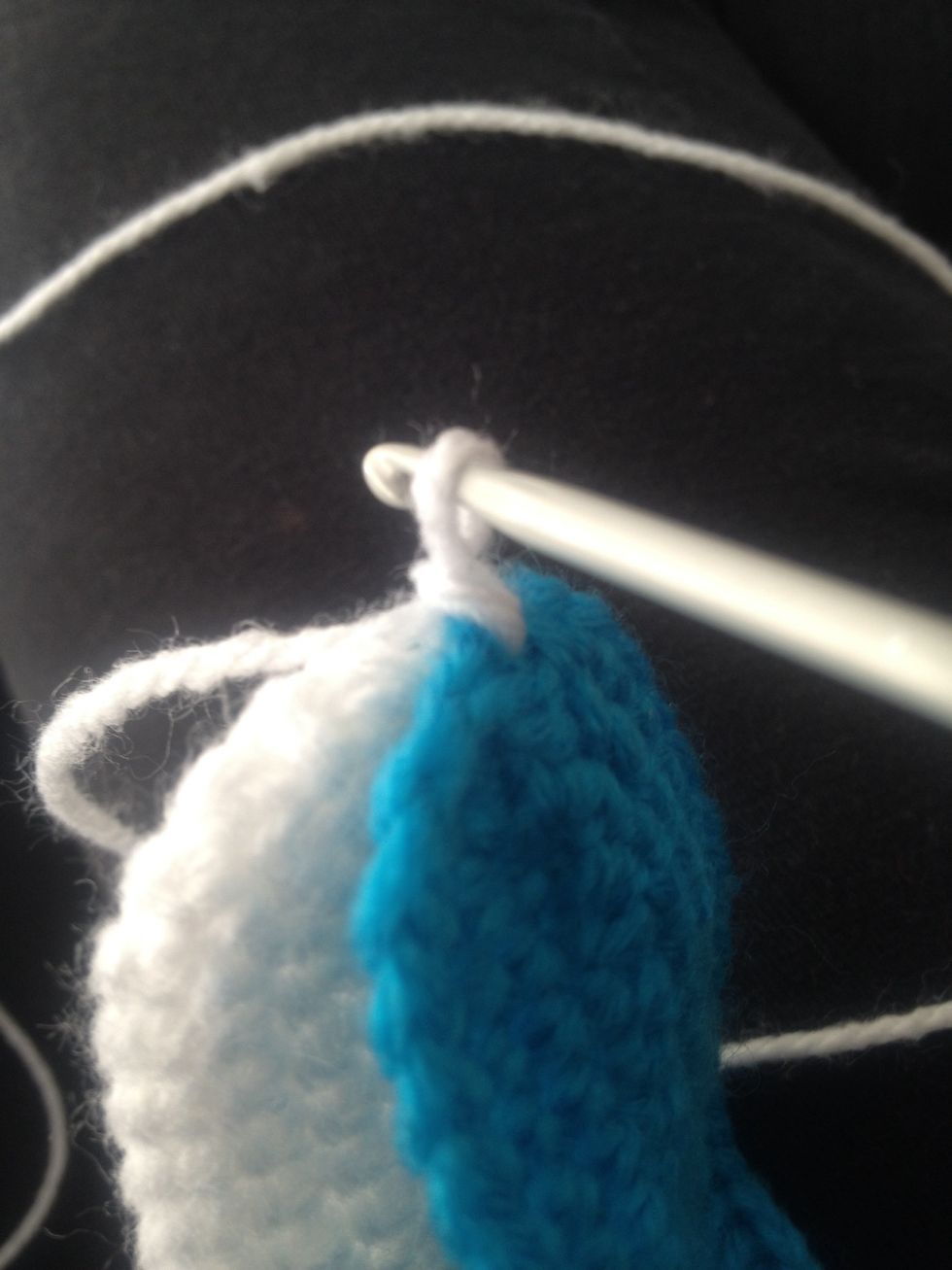 Hook yarn and pull through both stitches and create a slip stitch.