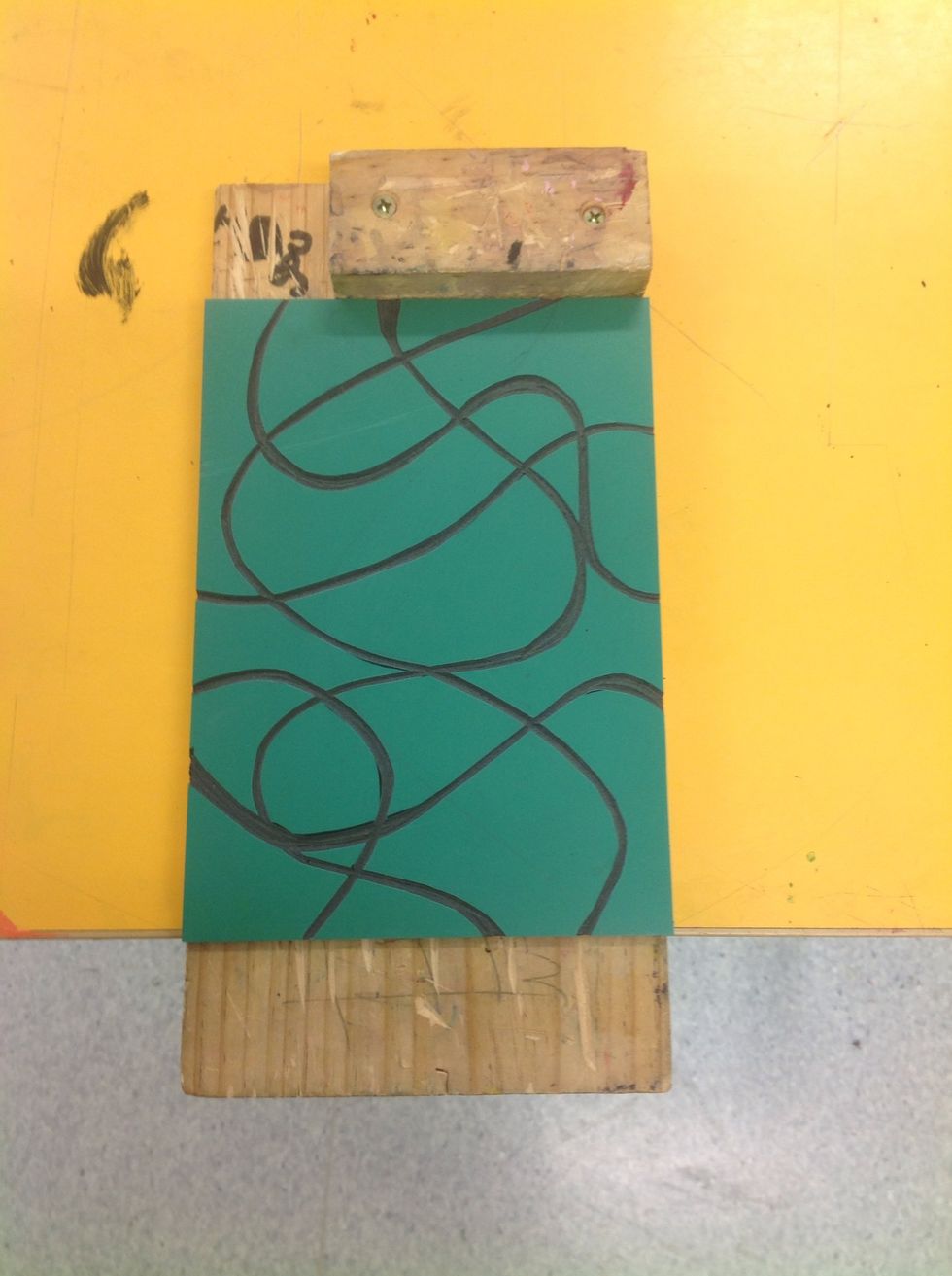 Hook you bench hook over the edge of your work bench or desk. Ensure your your Lino is pushed (and kept) squarely up against the top guard before you begin carving.