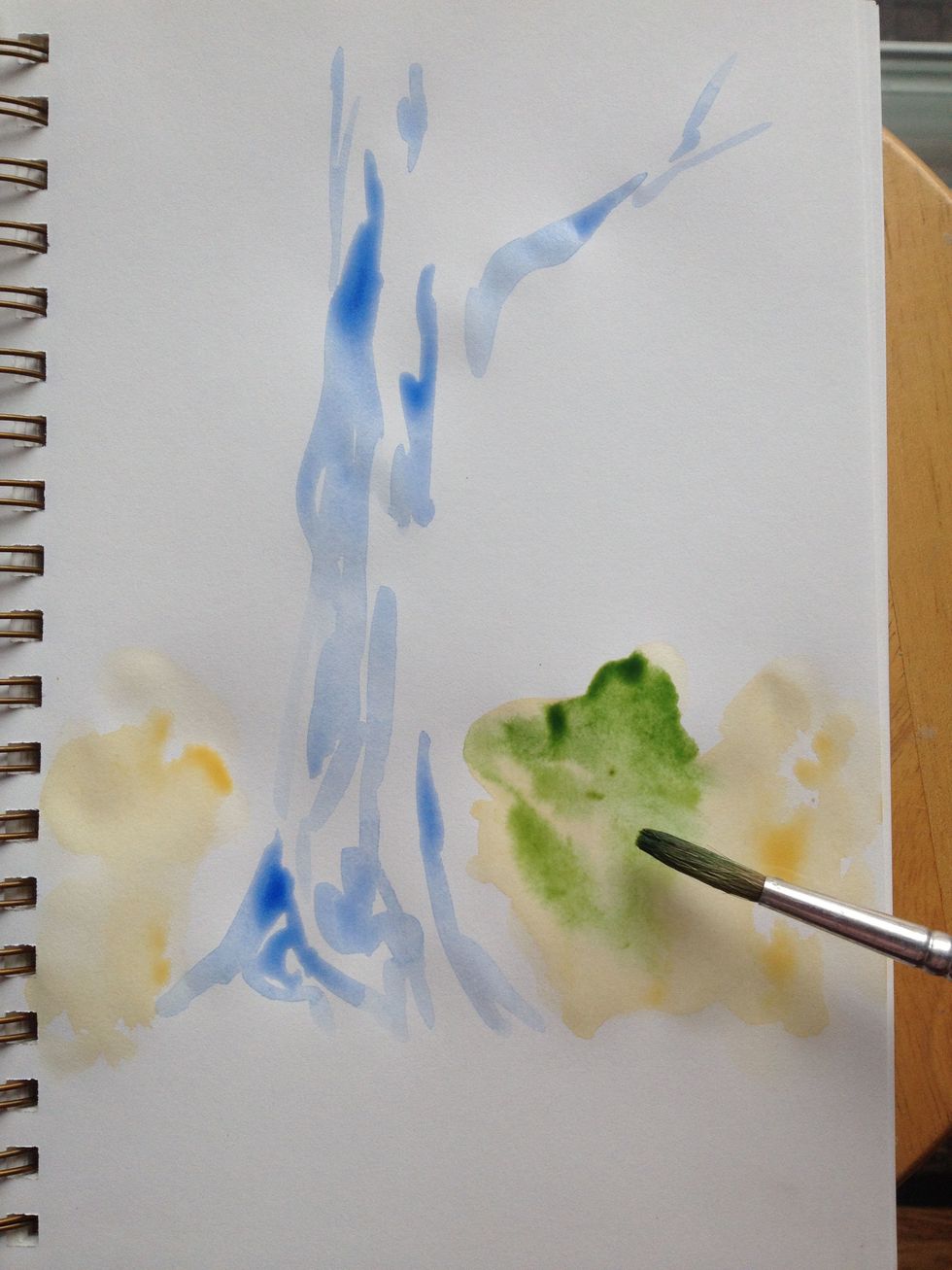 Hooker's green is added on top of the wet ochre to create bleeds. The random pattern of yellow to green will help define the foliage. Make sure you leave some ochre as highlights.