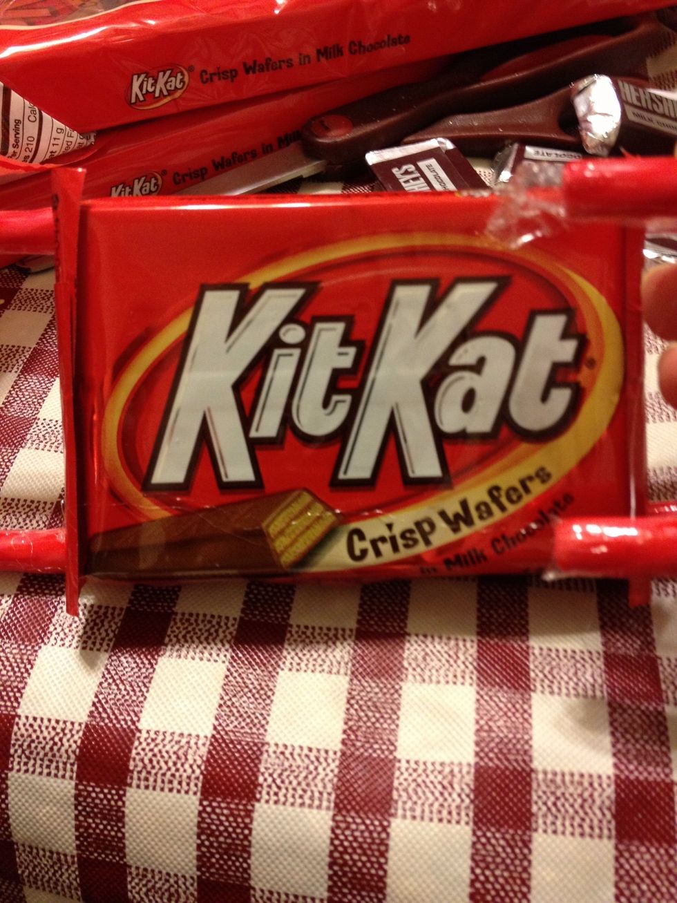 Hot glue the candy canes to kit Kat