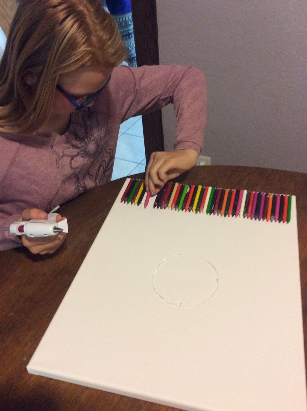 Hot glue the crayons in the way u want them