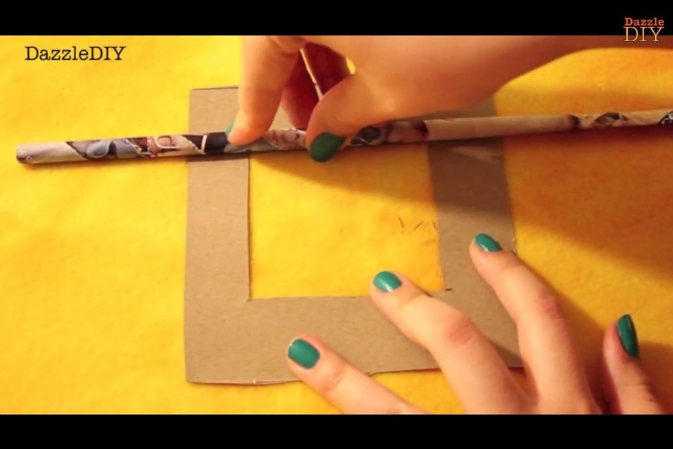 Hot glue the magazine rolls onto the farme in any pattern you want