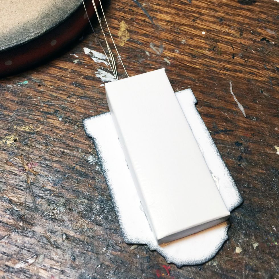 Hot glue the matchbox over the LED wires as shown.