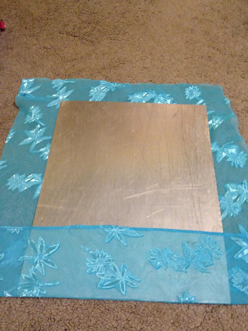 Hot glue the material to the back of the sheet metal. I doubled my material so the glue wouldn't seep through the fabric. Make sure the corners are extra secure