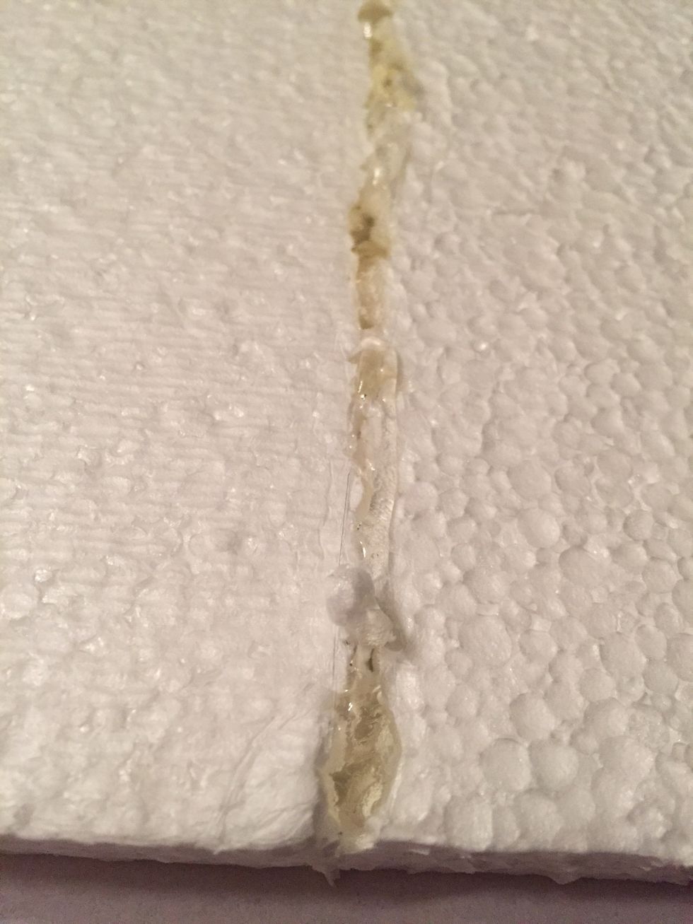 Hot glue the two pieces (if necessary). The styrofoam will melt, but don't worry, you'll get a better bond between the pieces. Add another layer of hot glue on top of the gap as well, and on back.