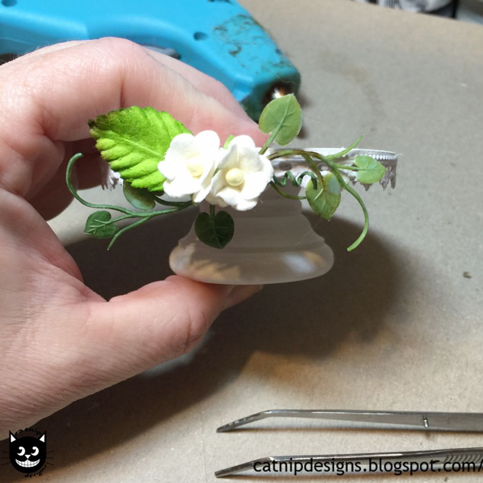 Hot glue them and one of the 1 Inch Mulberry Paper Rose Leaves on top of the Fern Garland.