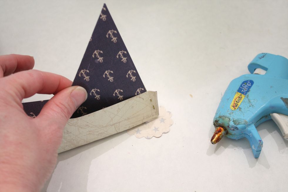 Hot Glue your boat to the base