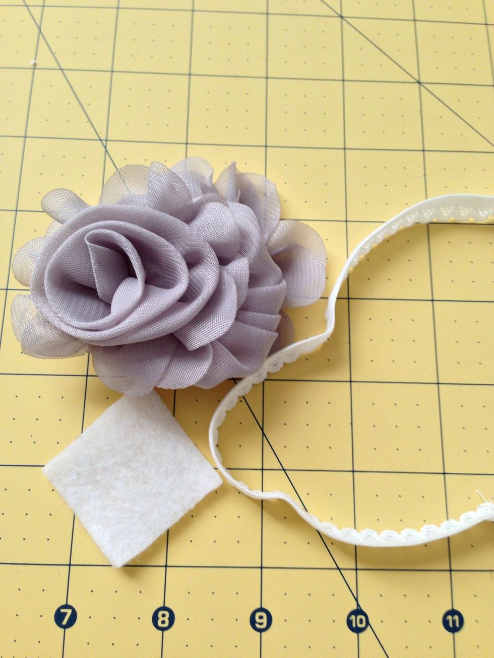 Hot glue your flower to the elastic and cover it with a piece of felt.