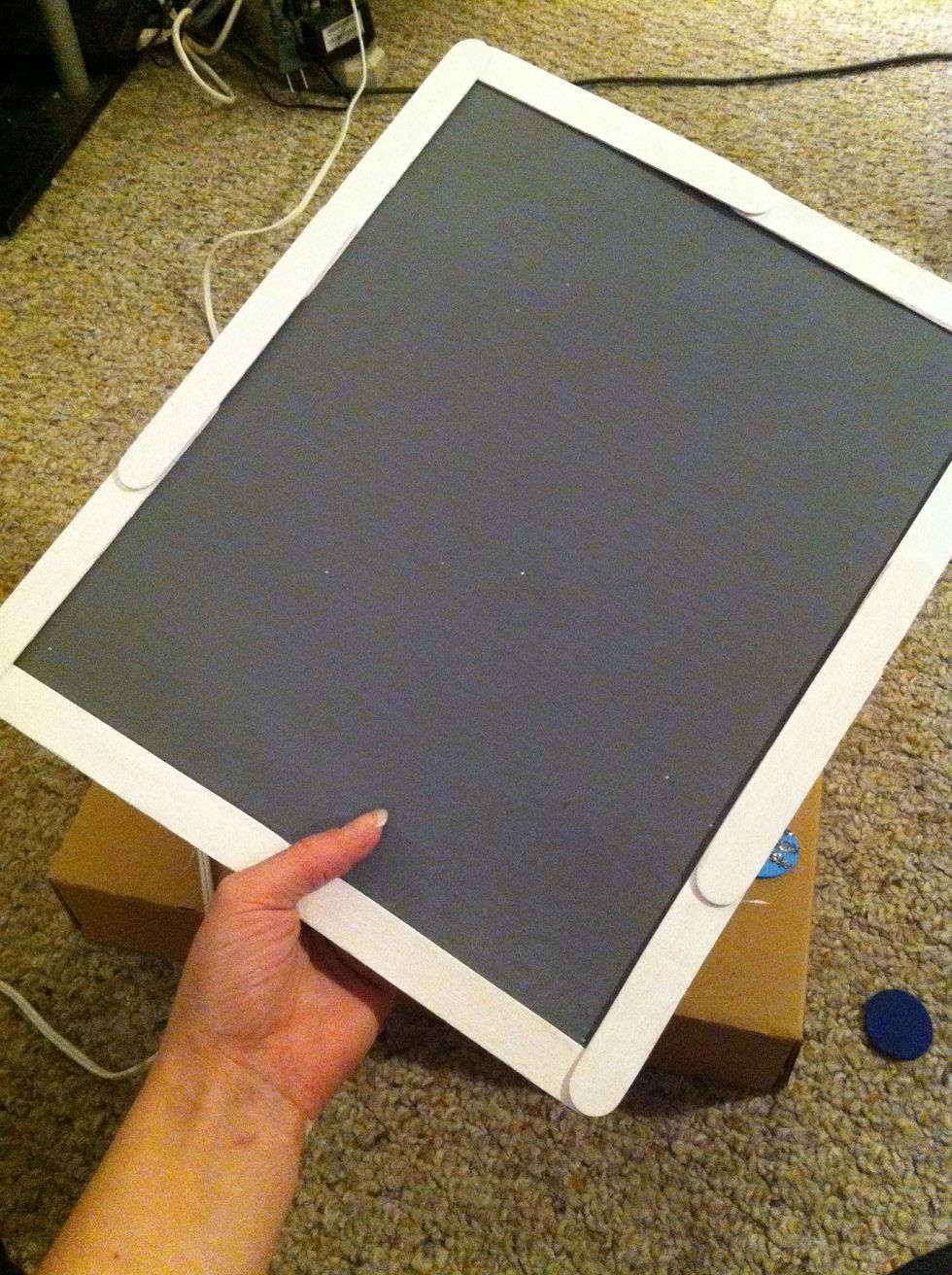 Hot glue your frame onto your piece of cardboard.