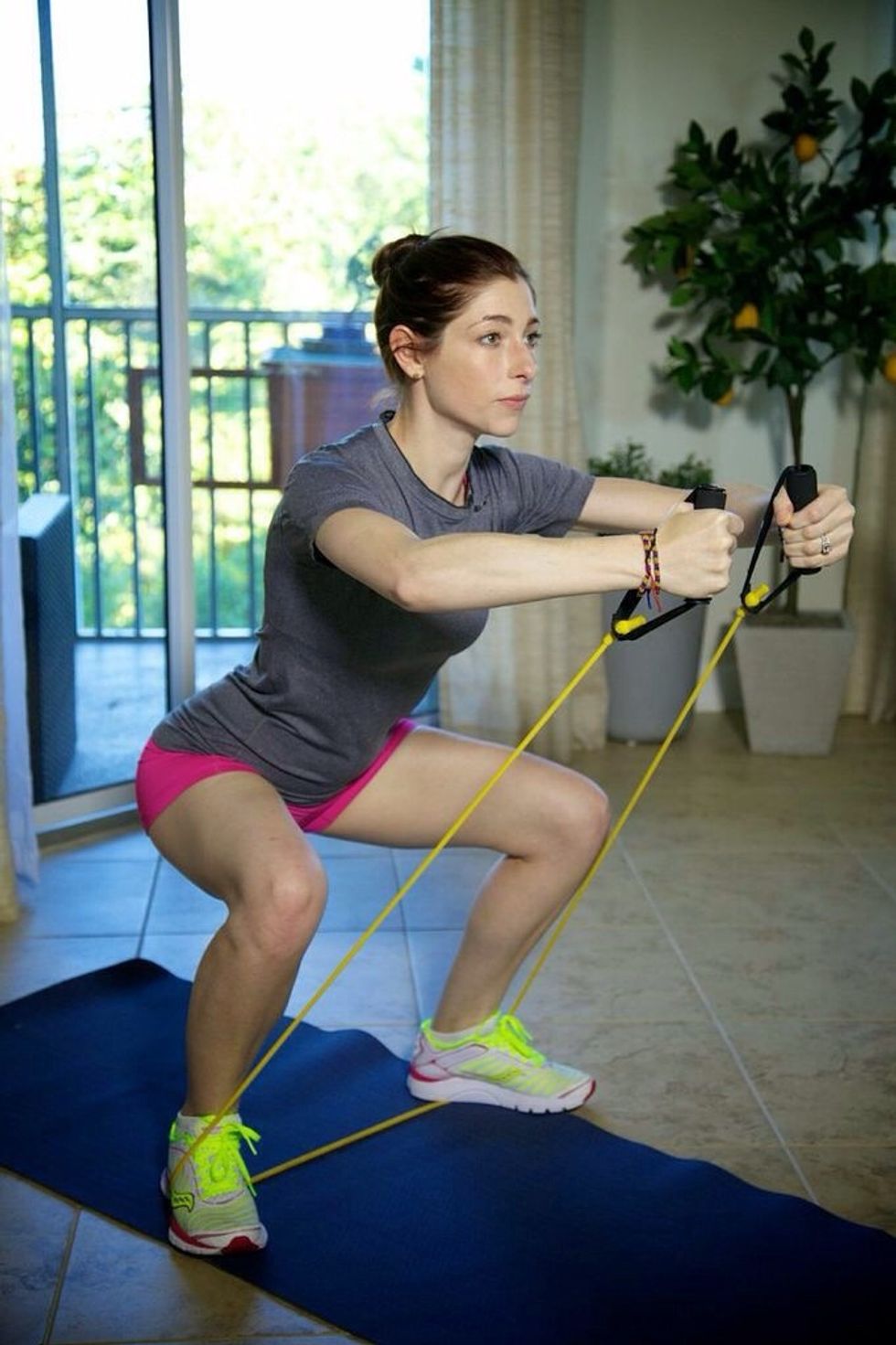 Hug the World Pli\u00e9 Part II: slowly bend legs into a pli\u00e9 while bringing hands into the center point of the body. Shoulders should be down, back straight, and arms parallel to the floor.