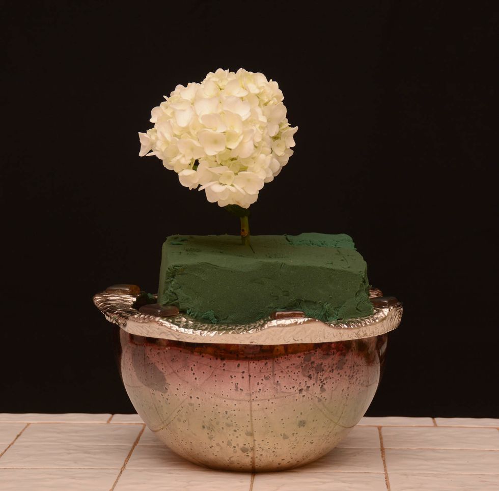 Hydrangea love water so make sure you add extra water in the container to the already wet foam. Place a single hydrangea as shown into the center of the foam