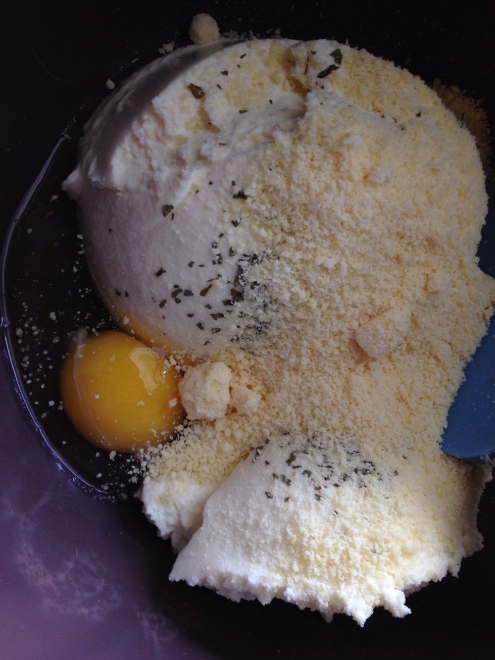 I a bowl add the egg, Parmesan, and ricotta with 1 table spoon chopped parsley.