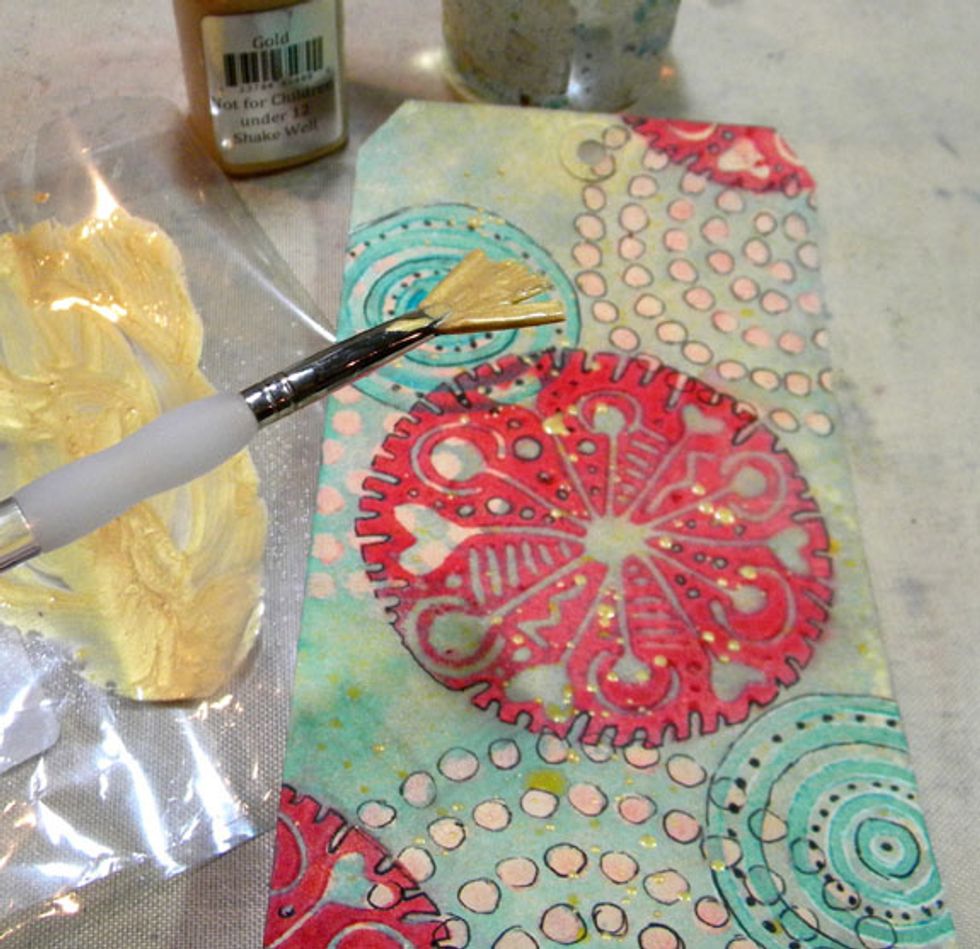 I added a bit of Gold Metal Effects and splatter it around the tag liberally. Once that was dry, I added some patching tape painted black, hearts and ribbon.