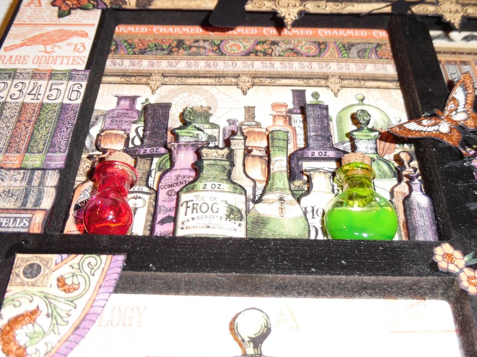 I added a couple of glass bottles to accentuate the 3D effect of the shelf. Bottles were part filled with "Glossy Accents" and a few drops of alcohol inks - shaken not stirred - and left to dry.