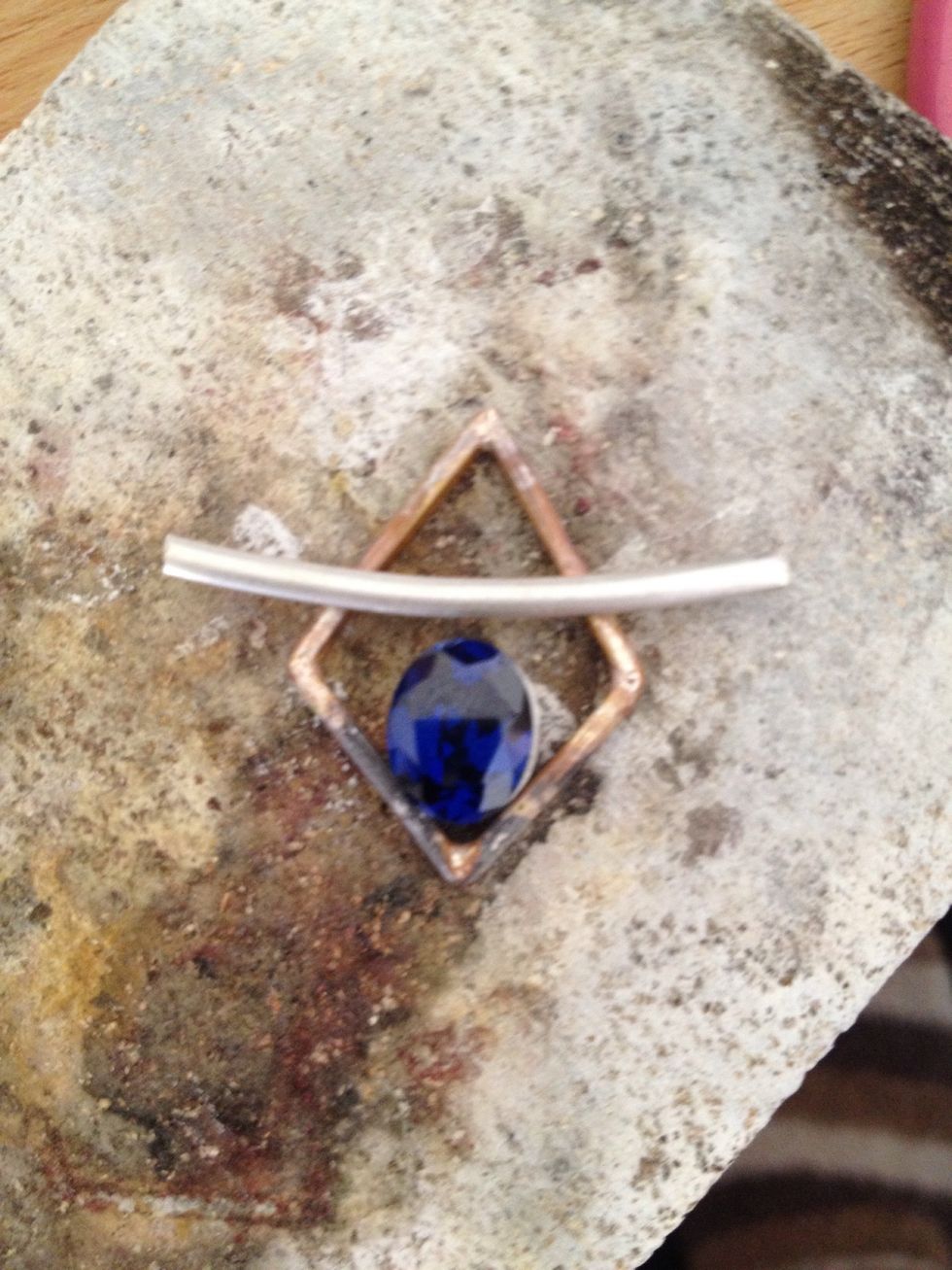 I added a curved piece of D shaped wire on top of the design. Make the two pieces fit together better by filing away from the top of the diamond shape, bottom of curved shape, where required.