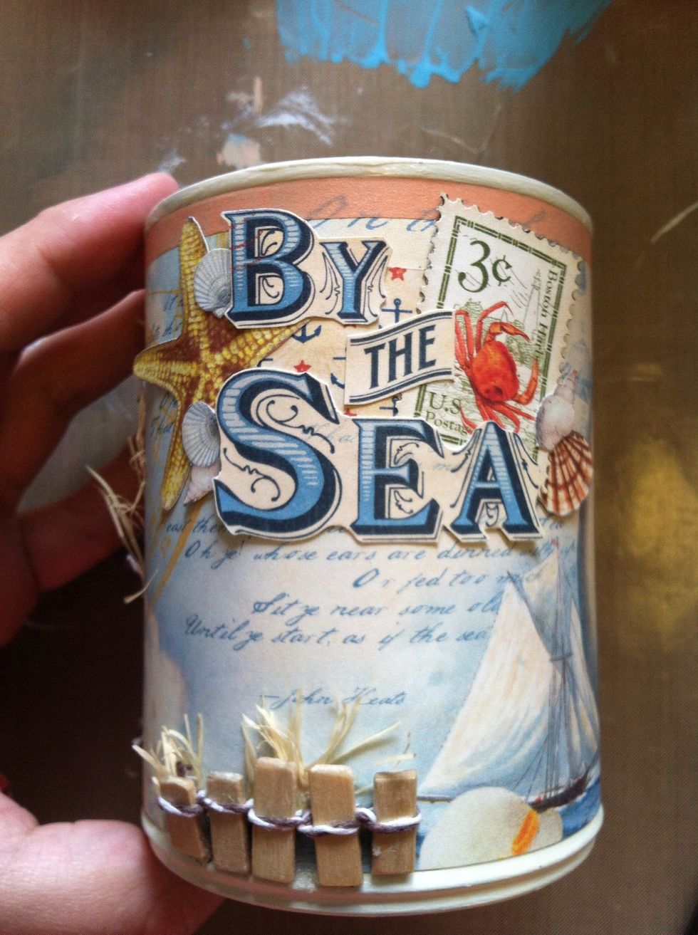 I added a few of the shells randomly. Just do whatever you think looks good! I adhered the whole thing to the can, just to the left of the woman's face.