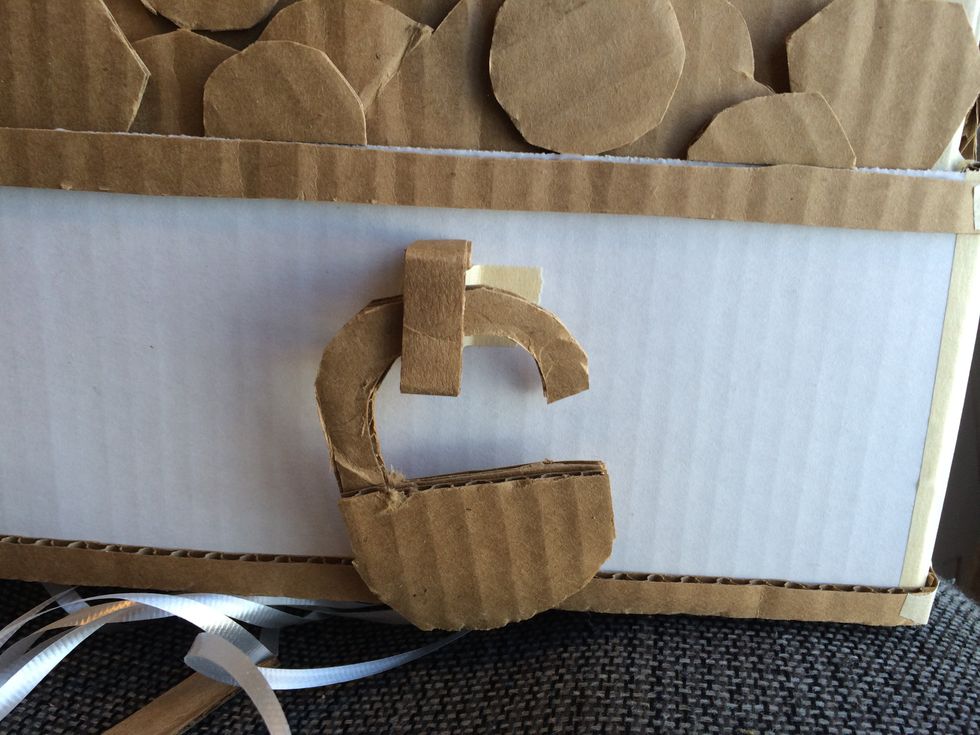 I added a little latch and lock out of cardboard too. In hindsight, it might have been easier to paint if I did this separate and attached it later, but it worked.