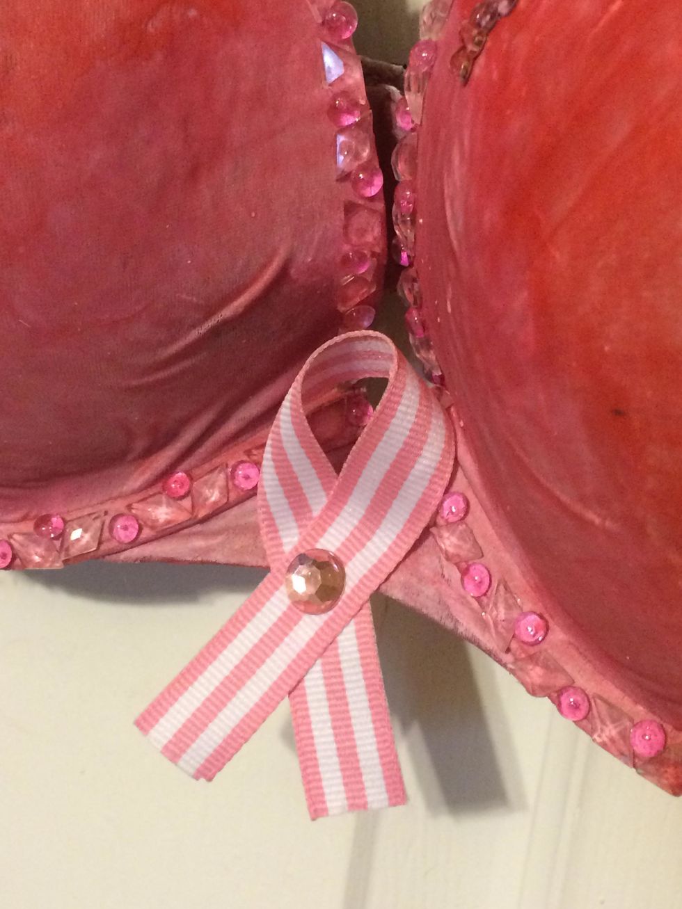I added a pink stripe ribbon in shape of the 'cause' with a pink gem in the center.