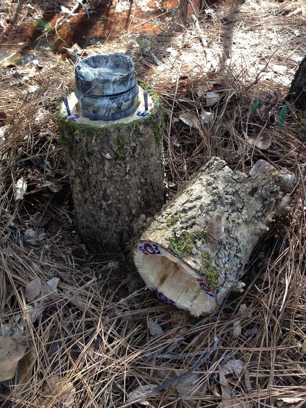 I added corresponding numbers to the top and bottom so geocachers could put it back together correctly and easily. I glued moss around the saw cut to help disguise it.