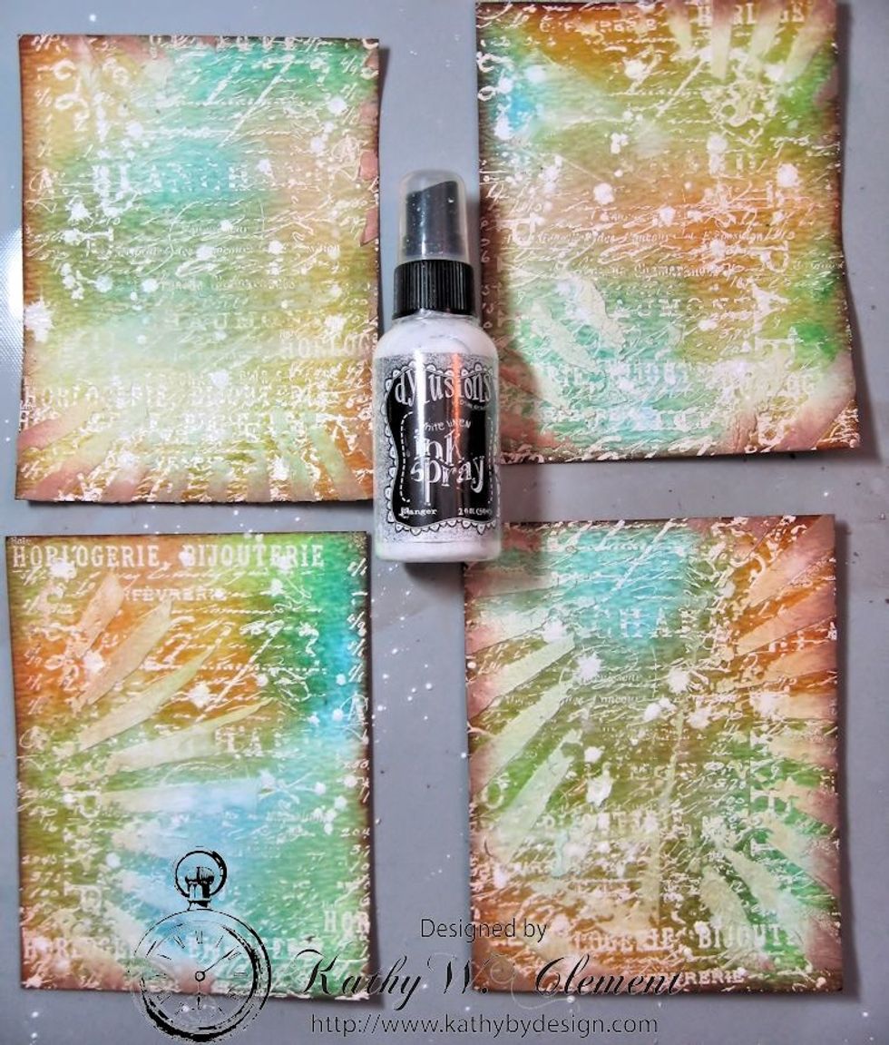I added inky spatters with Dylusions Linen Spray. I spattered the surface by taking the top off the bottle and using the tubing to splatter the ink. Heat dry.