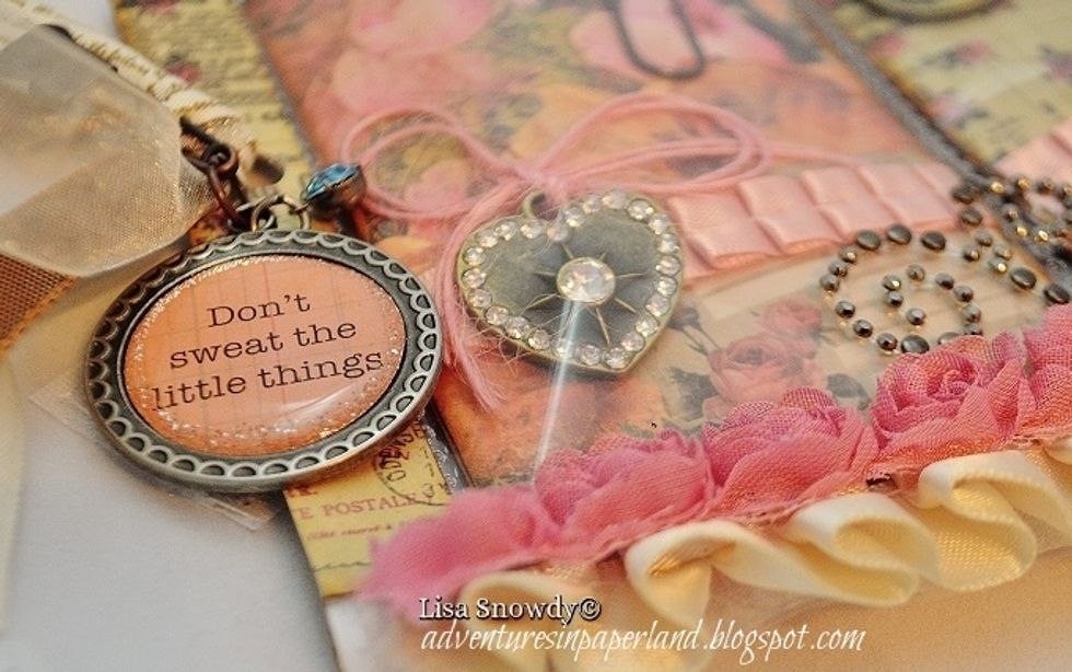 I added metal elements by Prima to the pocket and a metal charm by Girl's Paperie to the spine of the pocket letter.