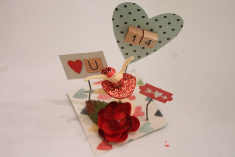 I added my focal piece- a Ballerina and a Petaloo Mixed Textured Blossom in red with my hot glue gun. I also added the little wood pieces