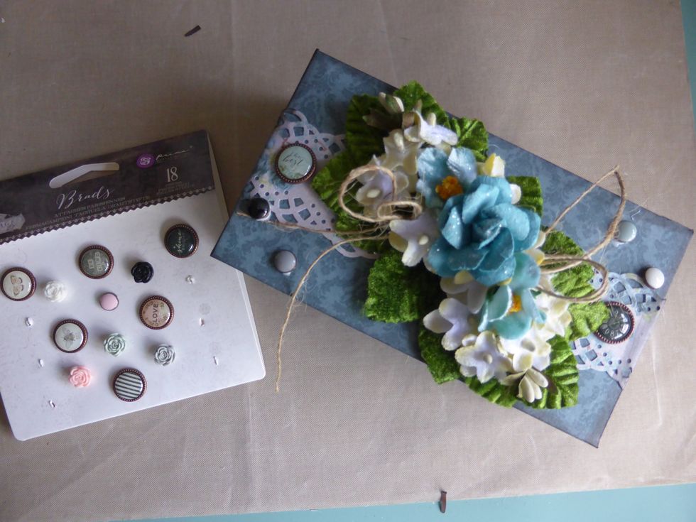 I added one large and two small Prima brads to both sides of the box. Plus two bows made from twine