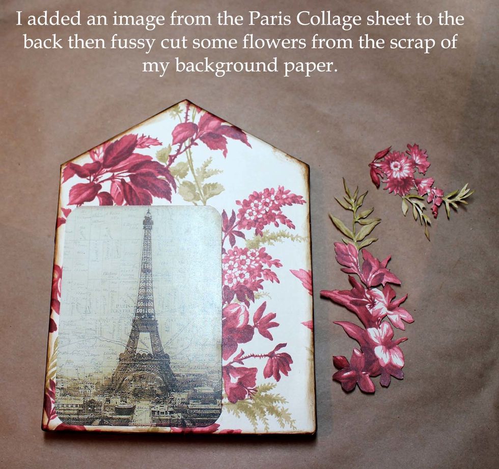 I added the Eiffel Tower image and distressed the edges, and fussy cut some flowers. I went around the flowers with a vintage Photo distress pen to color the white edges before gluing them down.