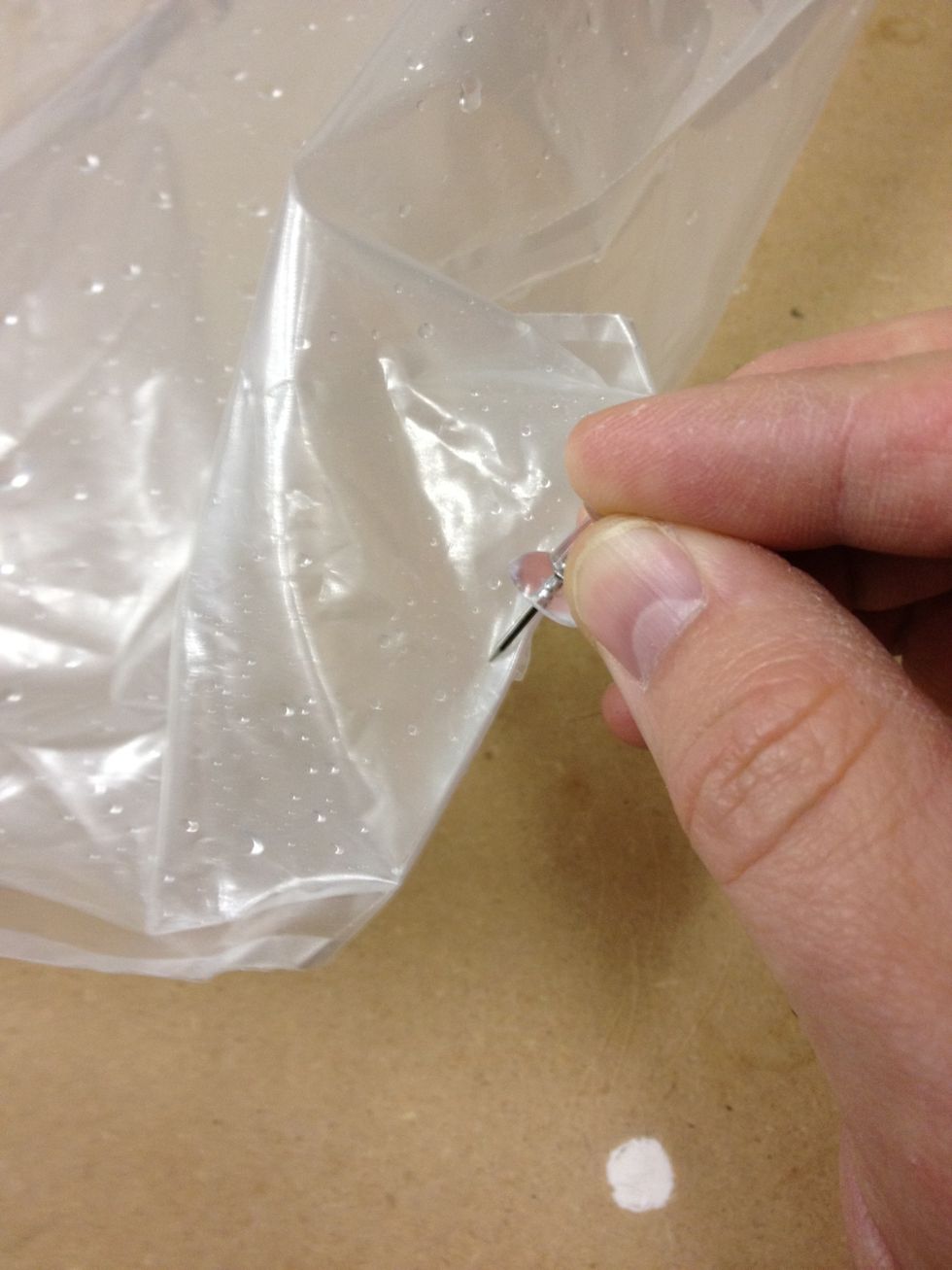 I added two holes at the bottom of the bag opposite the corner from the valve. After testing this, I'd start off with just 1 hole  - it drips more than you'd think. You can always add more holes later