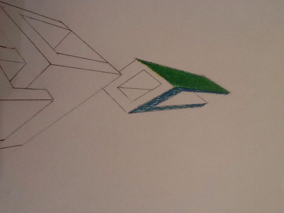 I added yellow to make it lighter then went back over it with green. On the next side, I did the same thing except to make it darker I used blue.